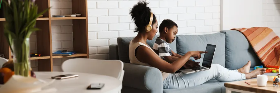 Family at home using affordable Spectrum Internet Assist on a laptop